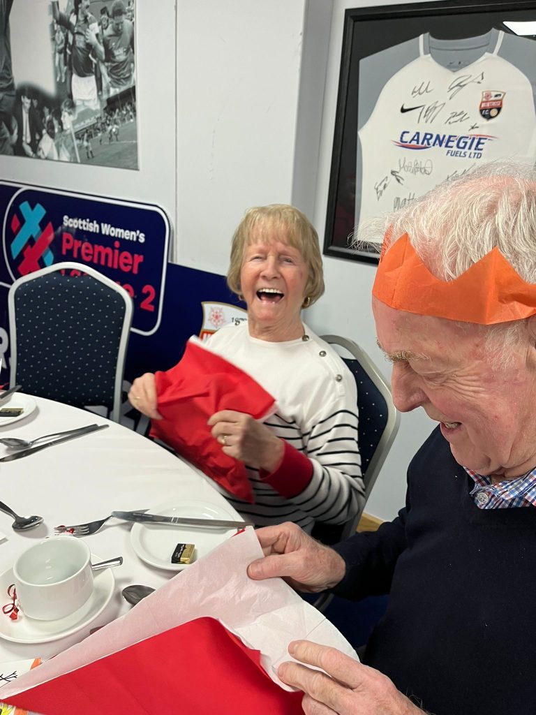 A man and woman enjoying Christmas dinner at MCT