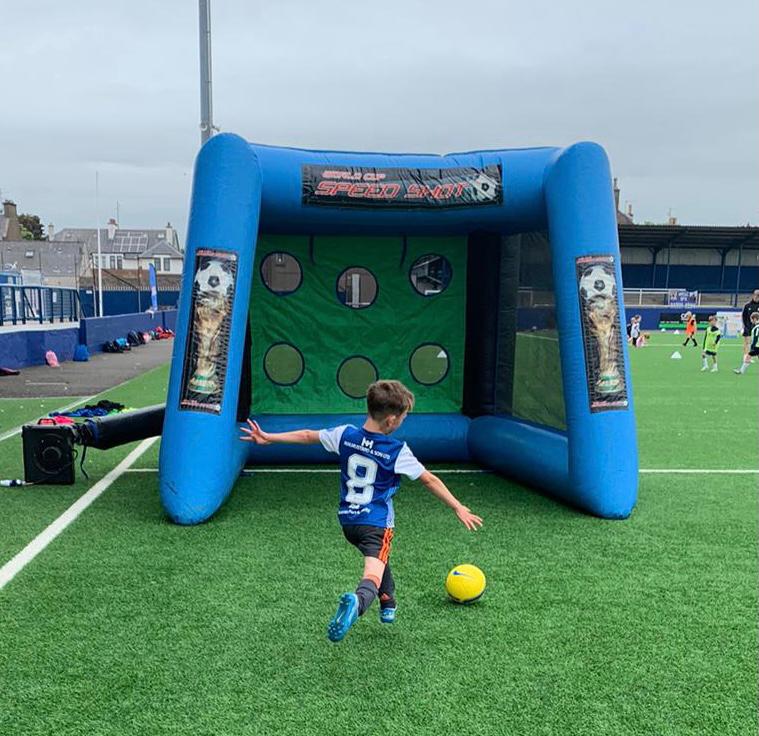 A boy plays a game at holiday camp